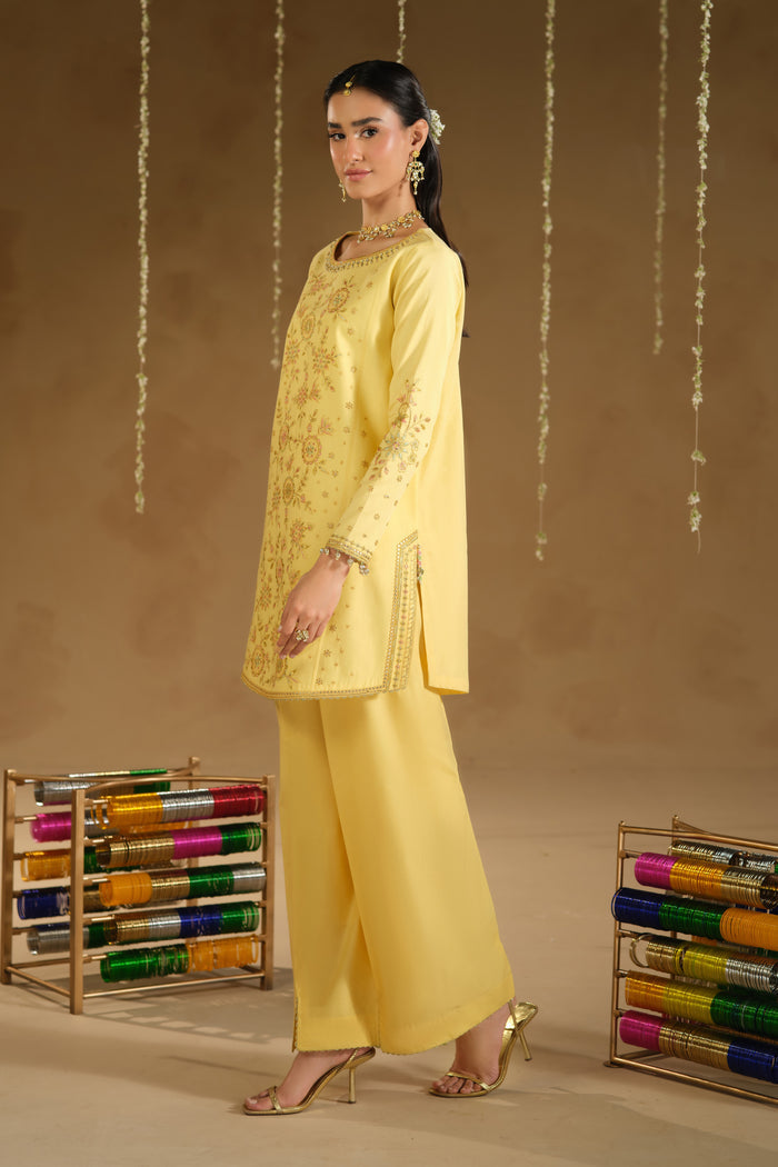 Side view of Aahal yellow festive dress showing long modest shirt silhouette and straight culotte trousers