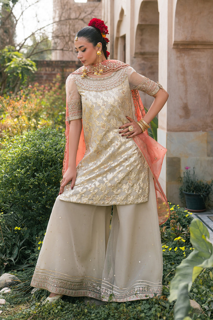 Side view of Ablaaj skin organza luxury pret outfit with embroidered shirt and flared pants