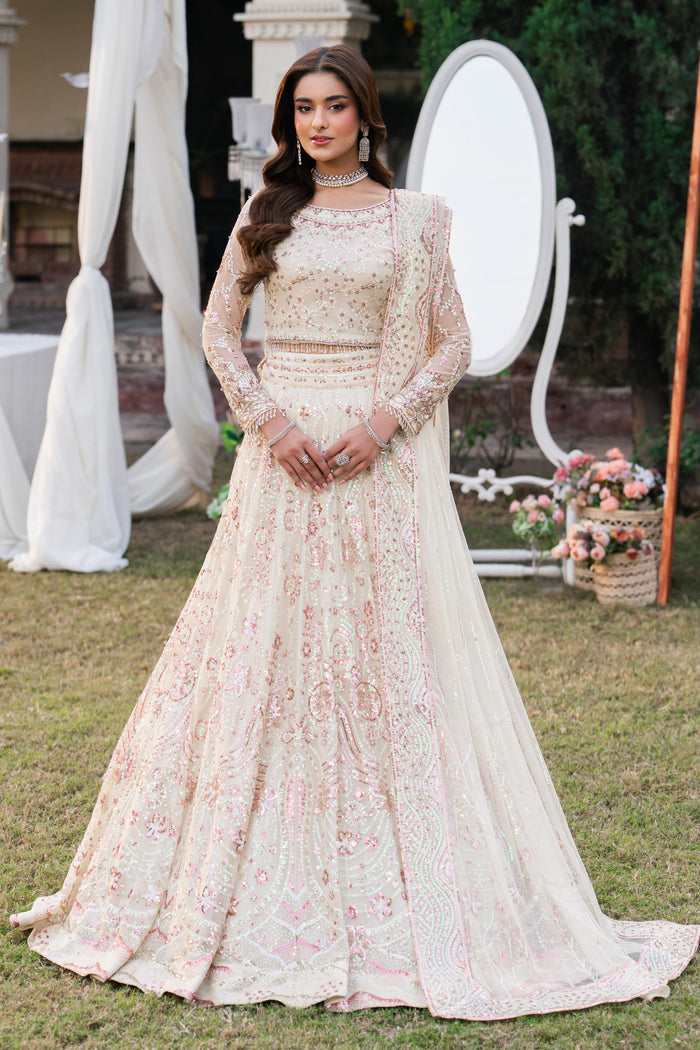 Woman in a floral dress standing outdoors with decorative elements in the background