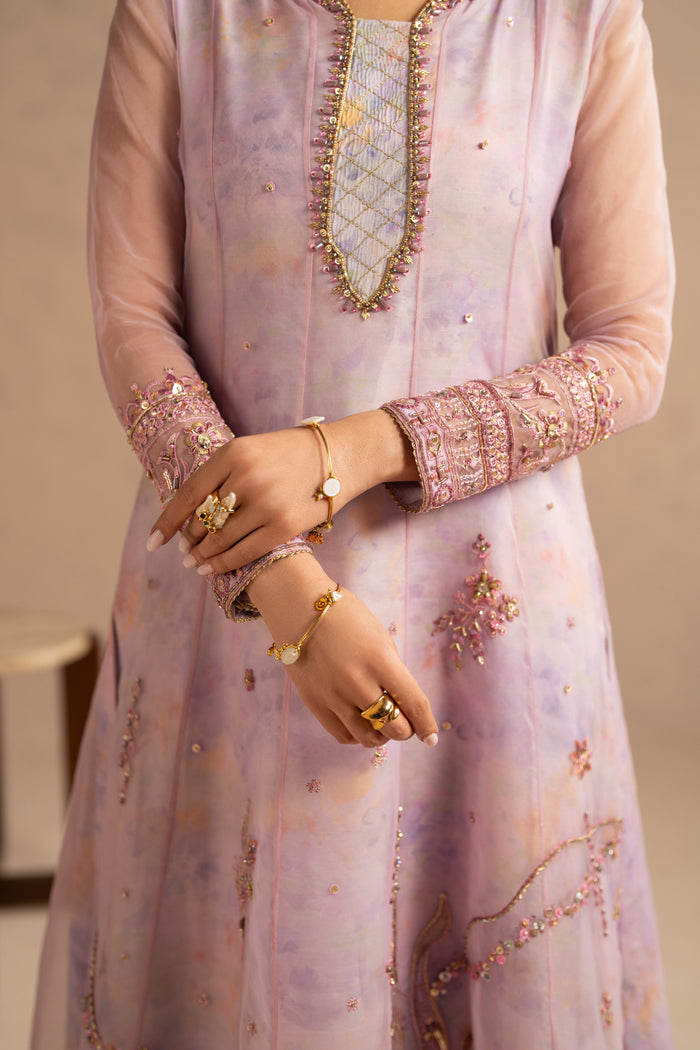 Close up of sleeves and cuff embroidery with tilla and fine motifs on mauve fabric, detailed formal pret design.