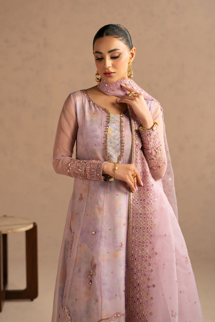 Portrait view focusing on neckline embellishment and soft mauve shade, graceful family function outfit.