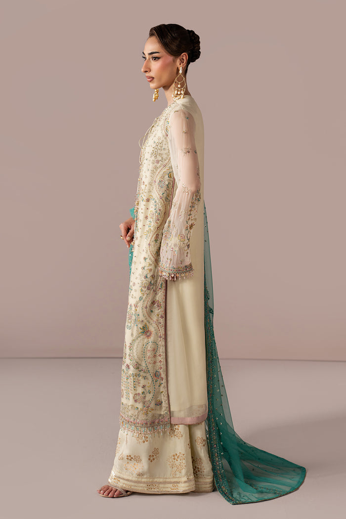 Side view of Alanah off-white semi-formal outfit highlighting the long Crinkle shirt, flared pants and flowing teal Net dupatta.