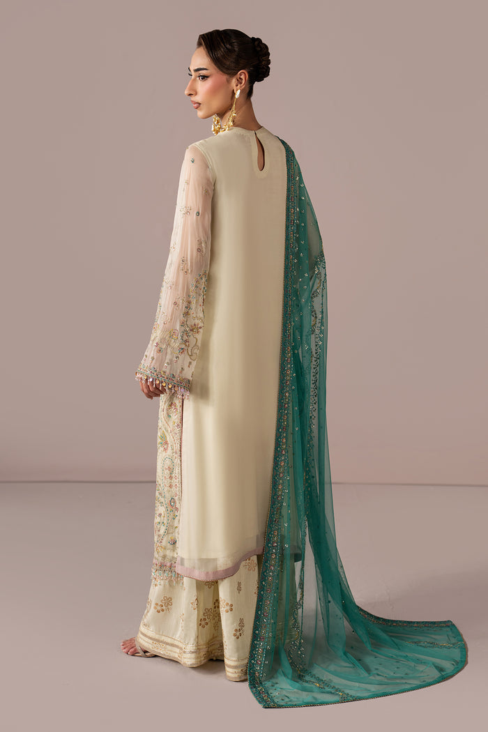 Back view of Alanah showing the long off-white open shirt silhouette, PK Raw Silk pants and contrast teal Net dupatta.
