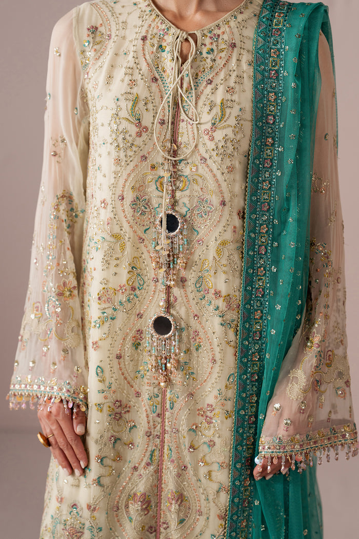 Close-up of Alanah showing machine embroidery, sequins, contrast detailing and sleeve trim on the off-white Crinkle shirt.