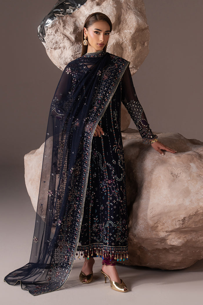 Alishma navy blue outfit in three-quarter view showing the embroidered shirt, sheer Net dupatta and contrast lower detailing.