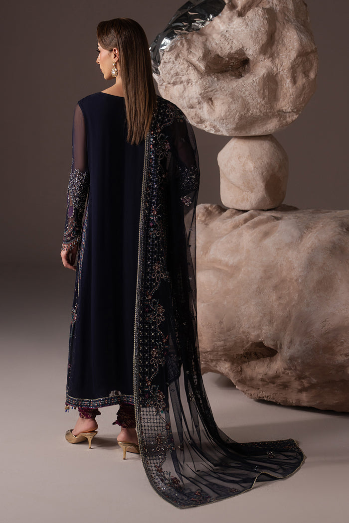 Back view of Alishma showing the long navy blue shirt and flowing embroidered Net dupatta.