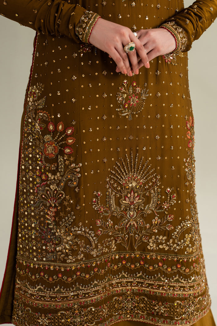 Close-up of deep brown formal shirt showing detailed embroidery and heavy hem border, premium stitching and fabric finish
