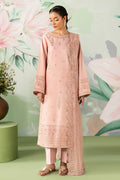 Woman wearing a pink embroidered outfit with a floral background