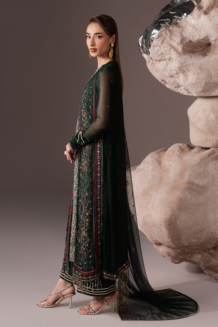 Three-quarter view of Arfiya showing the deep green embroidered Crinkle gown, contrast detailing and flowing semi-formal silhouette.
