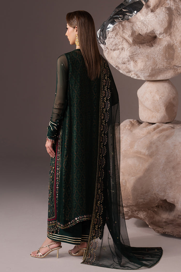 Back view of Arfiya highlighting the long green gown, extended sleeves and flowing embroidered Net dupatta.