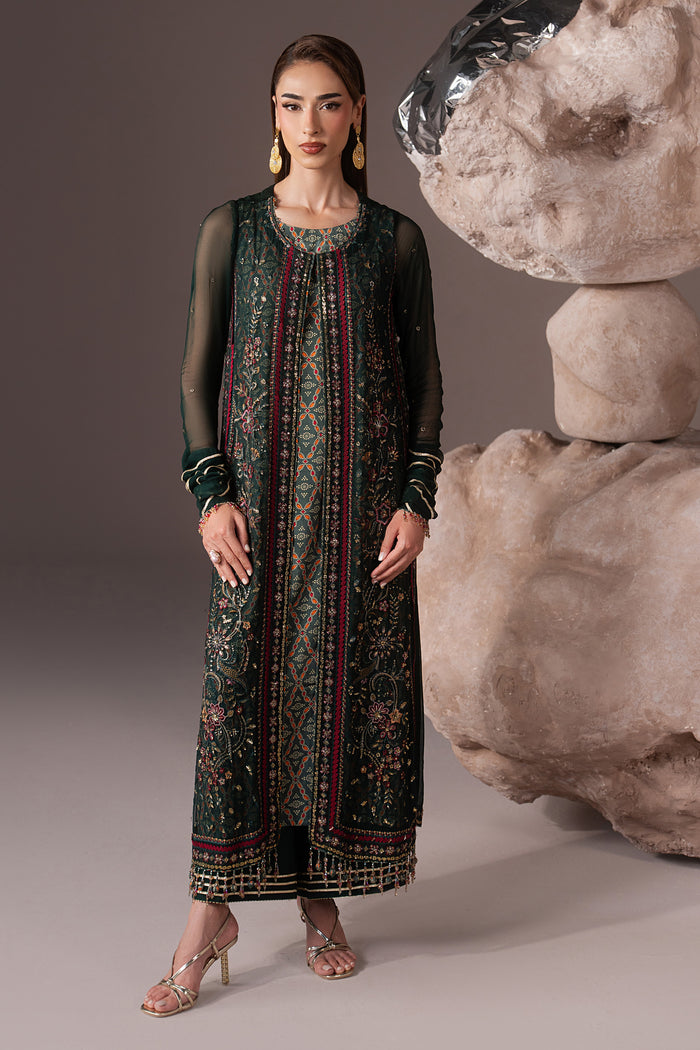 Full-length front view of Arfiya showing the green embroidered gown, PK Raw Silk culotte and coordinated Net dupatta.