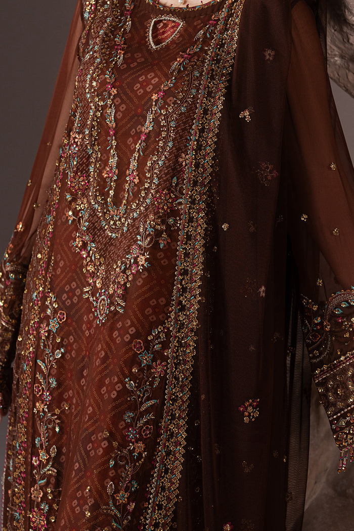 Close-up of Aroob showing machine embroidery, sequins, decorative trims and detailed finishing on the chocolate brown shirt.