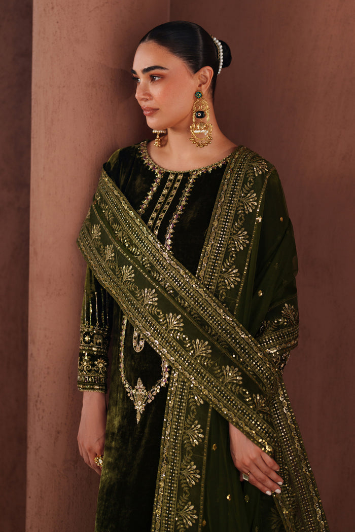 Close-up view of NAQSHI dark green formal dress showing detailed embroidery on neckline and front panel