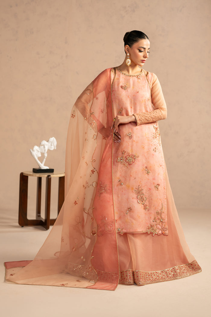Side angle of Aysun outfit showing long modest fall, layered organza shirt with digital inner and bordered sharara, occasion wear dress.