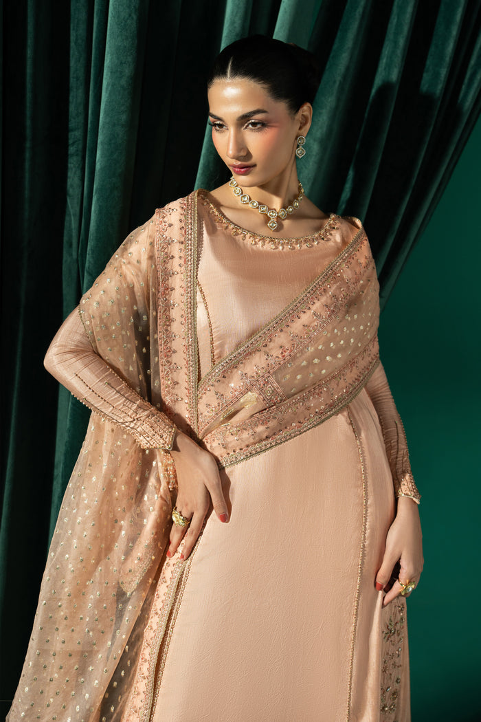 Front view of Azba with the embroidered Organza Barosha dupatta draped over the peach A-line frock and flared sharara.