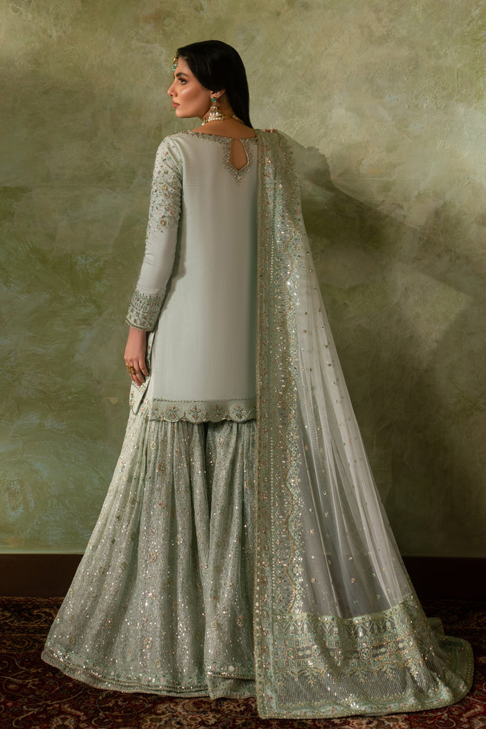 Back view of Azeyma pistachio formal Nikkah outfit showing full sharara flare and bordered net dupatta drape, complete ready to wear bridal attire.