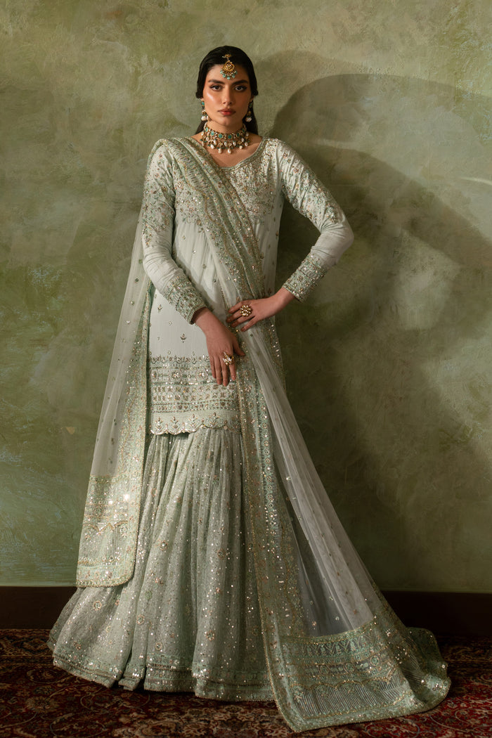 Full standing pose of Azeyma pale pistachio sharara suit featuring balanced silhouette, soft net layers and clean hem borders, formal Nikkah ready outfit.