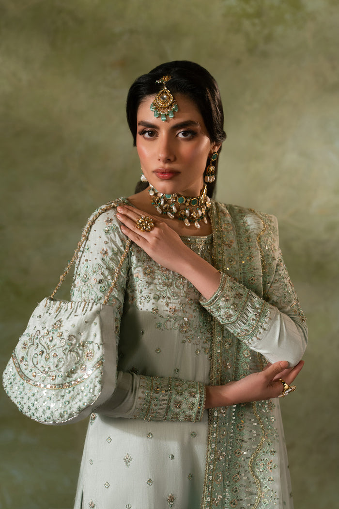 Upper body portrait of Azeyma Nikkah dress highlighting sleeve detailing, raw silk texture and dupatta styling, elegant modest bridal formal wear.