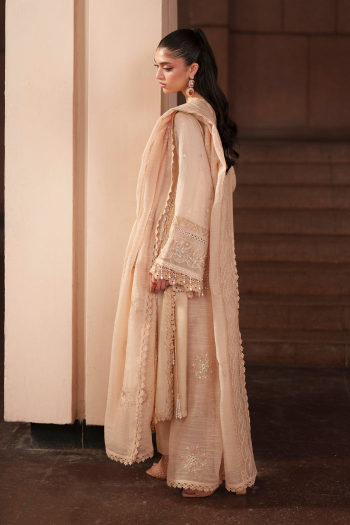 Side view of Beatriz peach embroidered khadi net dress featuring flowing silhouette, wide flare and embroidered cotton organza dupatta