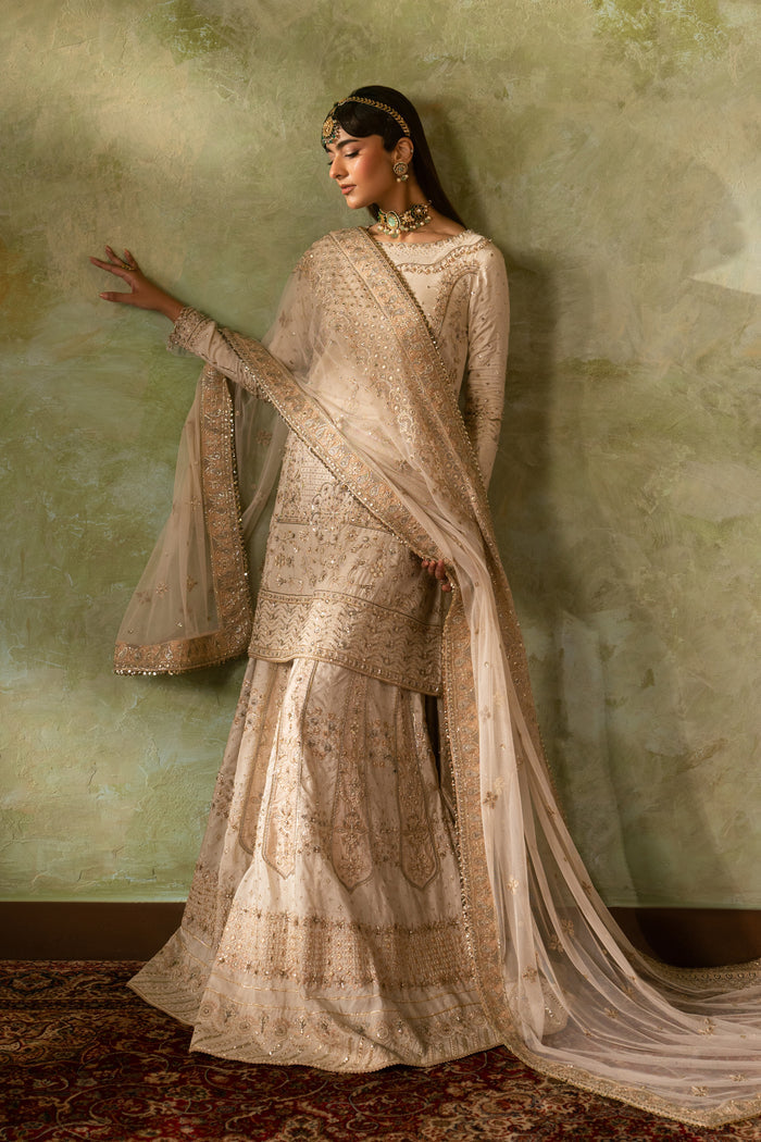Side drape pose of Damiya formal Nikkah outfit featuring flowing sharara and long dupatta trail, graceful modest ready to wear wedding attire.
