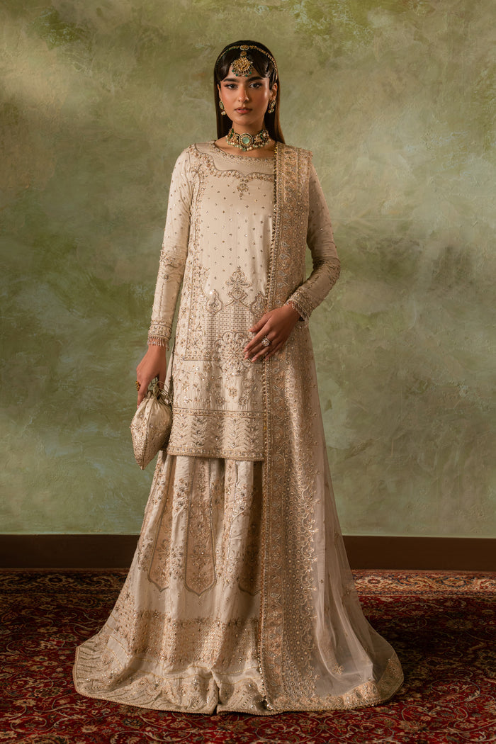 Full standing look of Damiya off white sharara suit highlighting balanced silhouette and clean embroidery detailing, formal ready made Nikkah outfit.