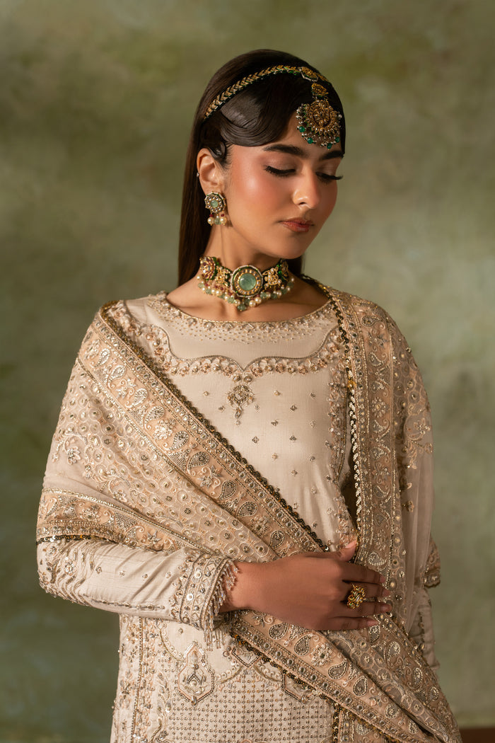 Upper body portrait of Damiya Nikkah dress showing neckline embroidery and dupatta styling in off white tone, elegant bridal formal wear.