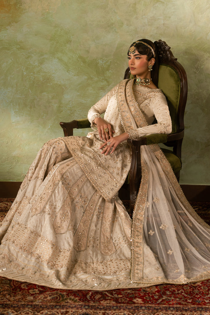 Seated styling view of Damiya outfit with wide sharara spread and soft dupatta fall, calm ready to wear wedding dress.