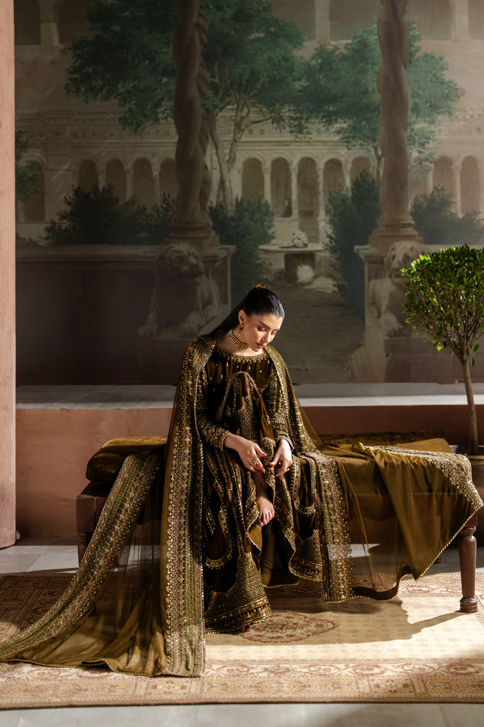 Woman in a long, patterned dress sitting on a bench with a classical painting in the background