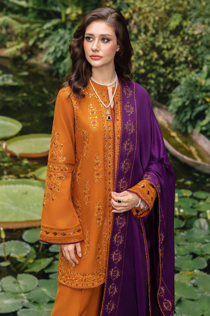 Woman wearing an orange and purple traditional outfit with a garden background