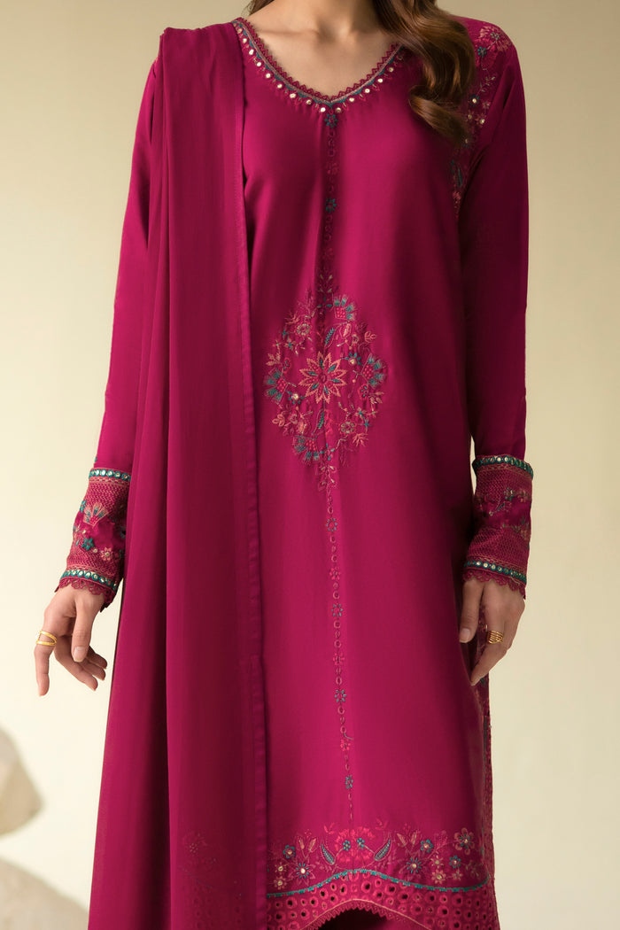 Close front view of Easten Shocking Pink shirt showing V-shaped neckline, centre motif and floral embroidery.