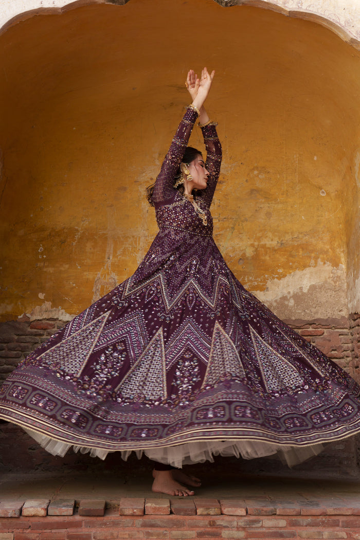 Emma plum Crinkle evening maxi in motion showing full nine-panel flare and embroidered hem.