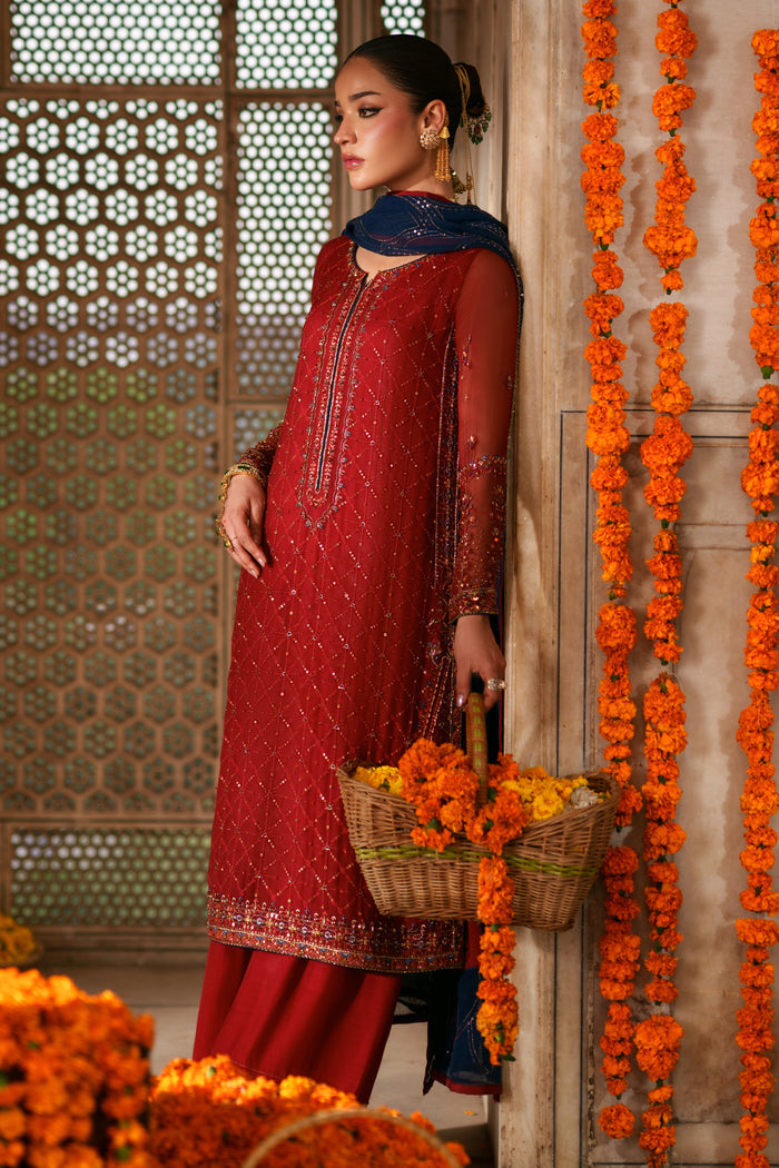 Side view of Faheel red and dark blue semi formal suit with flowing crinkle dupatta, long shirt silhouette and festive embellishments