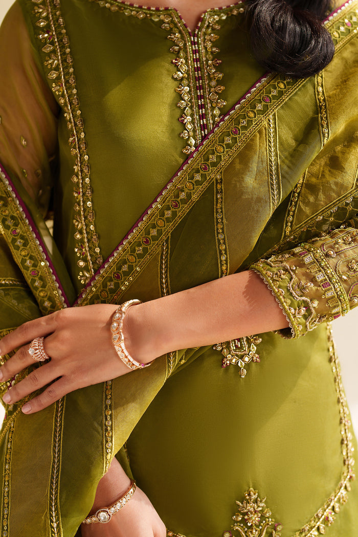 Green embroidered traditional outfit with gold detailing.