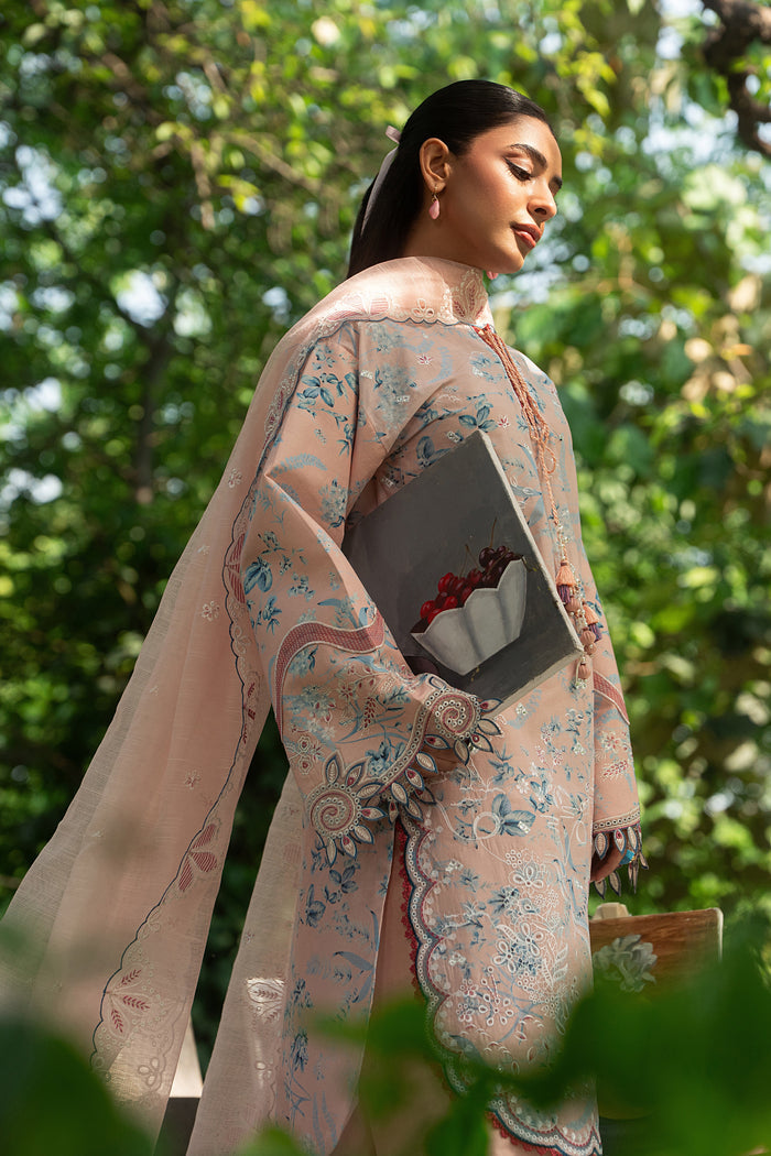 Side angle of Fizba pink lawn dress highlighting embroidered sleeves, subtle color stitching and soft fabric for daytime wear