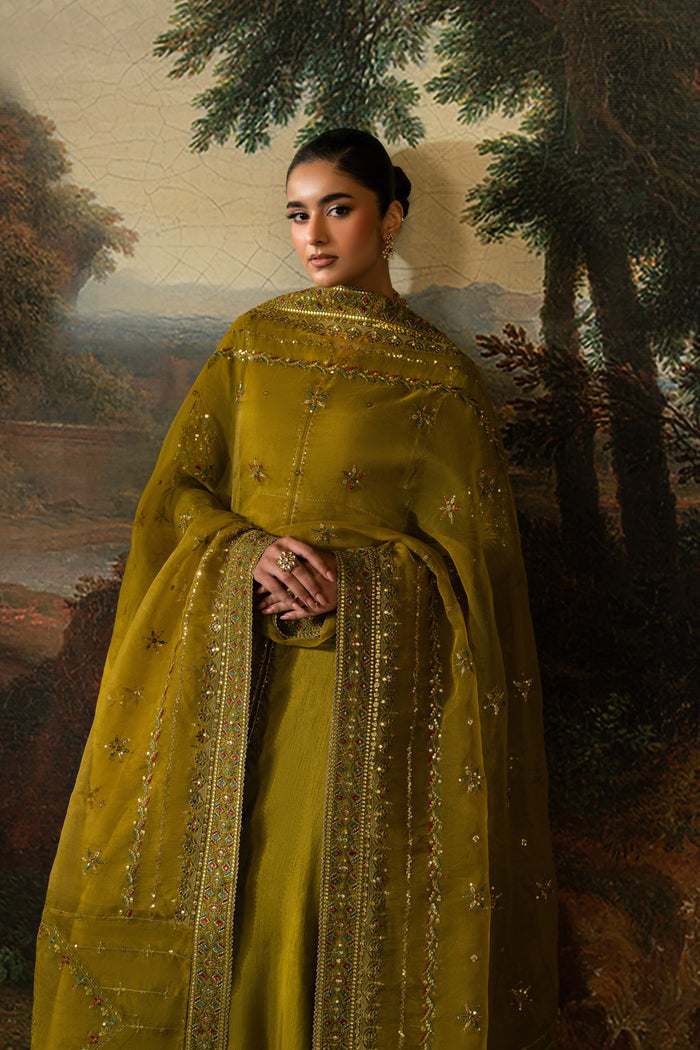 Three-quarter view of Ghina showing the olive green A-line frock, adda-work neckline, long sleeves and draped Organza dupatta.