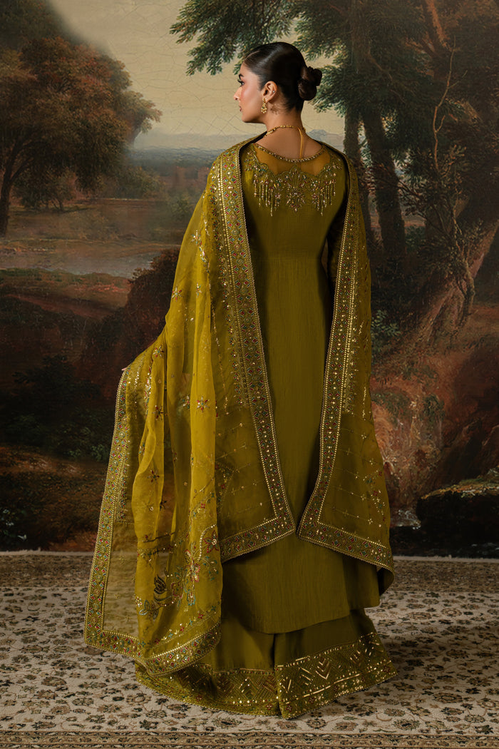 Side view of Ghina highlighting the A-line frock, side-open slit, wide sharara and flowing embroidered dupatta.