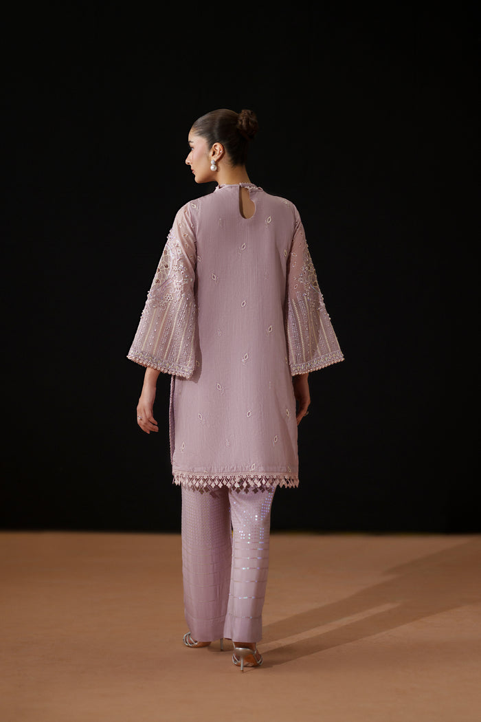 Back view of Gigil showing the relaxed Line Organza shirt, keyhole back detail and coordinated PK Raw Silk trousers.