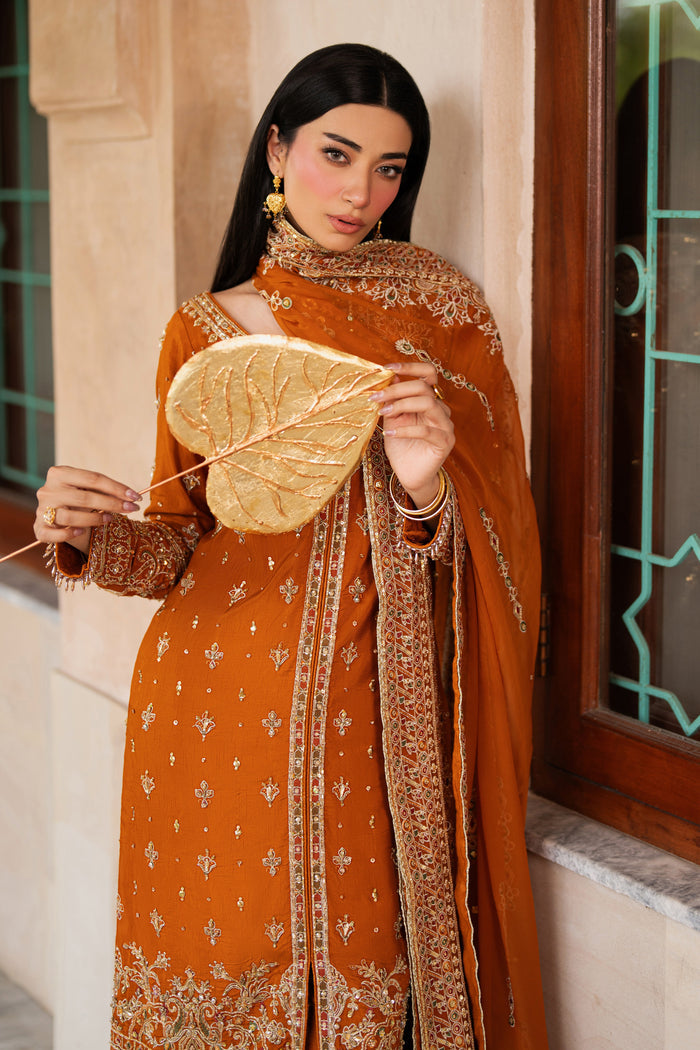Front view of NAQSHI Gul-e-Farosh rust raw silk gown with adda work, sequin spray embroidery, rounded neckline, and soft chiffon dupatta styled for formal wear.