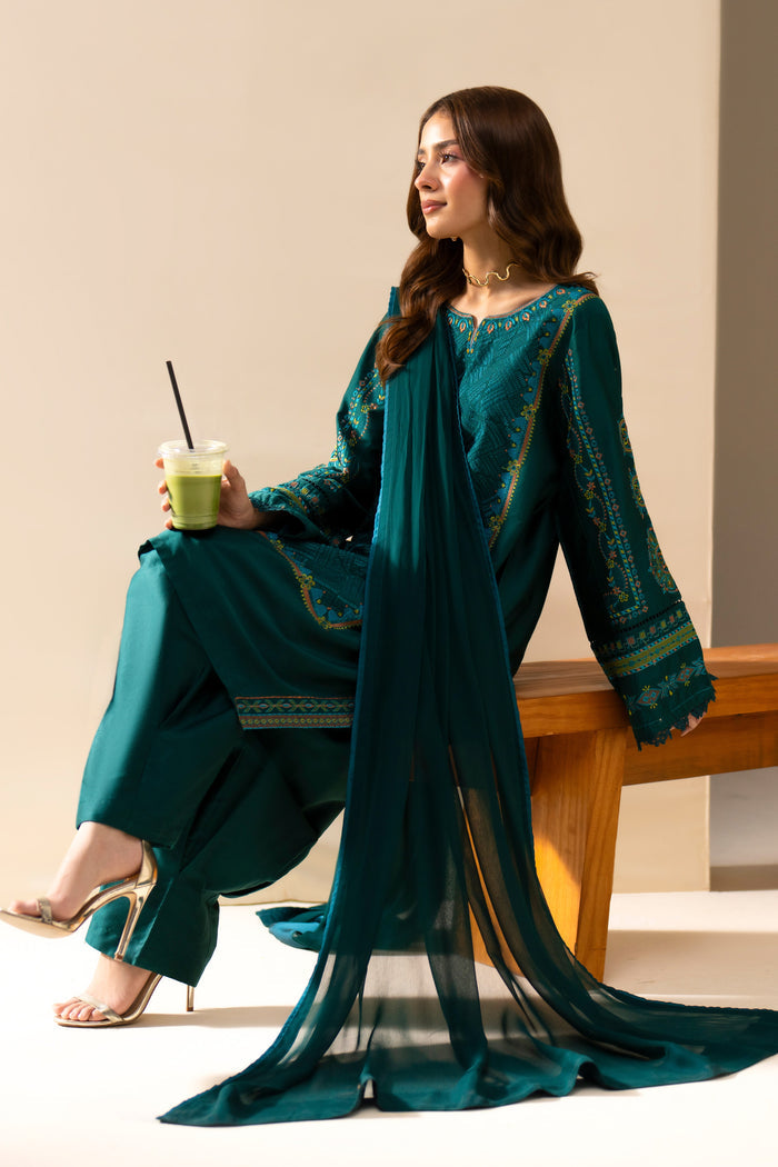 Gunash Emerald Green casual outfit styled seated with embroidered shirt, shalwar and Crinkle dupatta.