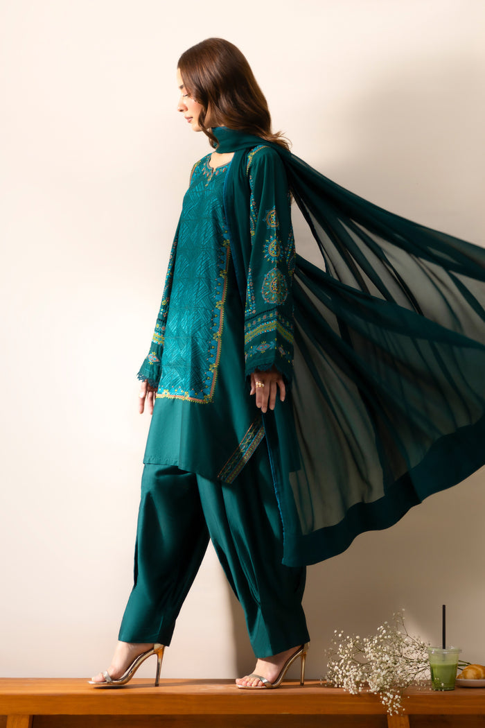 Gunash Emerald Green outfit side view with Cotton Sateen shirt, shalwar and flowing Crinkle dupatta.