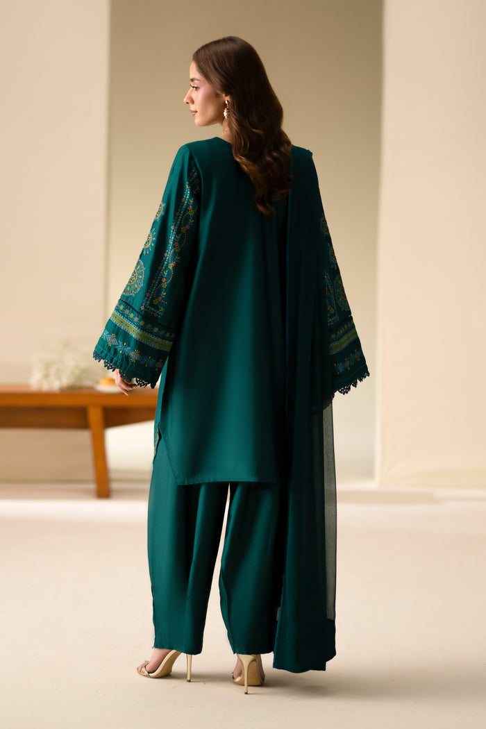 Back view of Gunash Emerald Green Cotton Sateen shirt and shalwar showing loose embroidered sleeves.