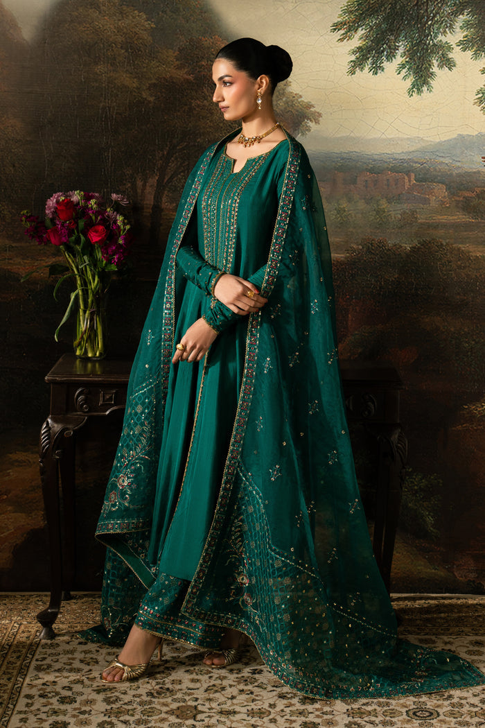 Three-quarter view of Haniya showing the bottle green panelled frock, flowing flare and draped embroidered Organza dupatta.