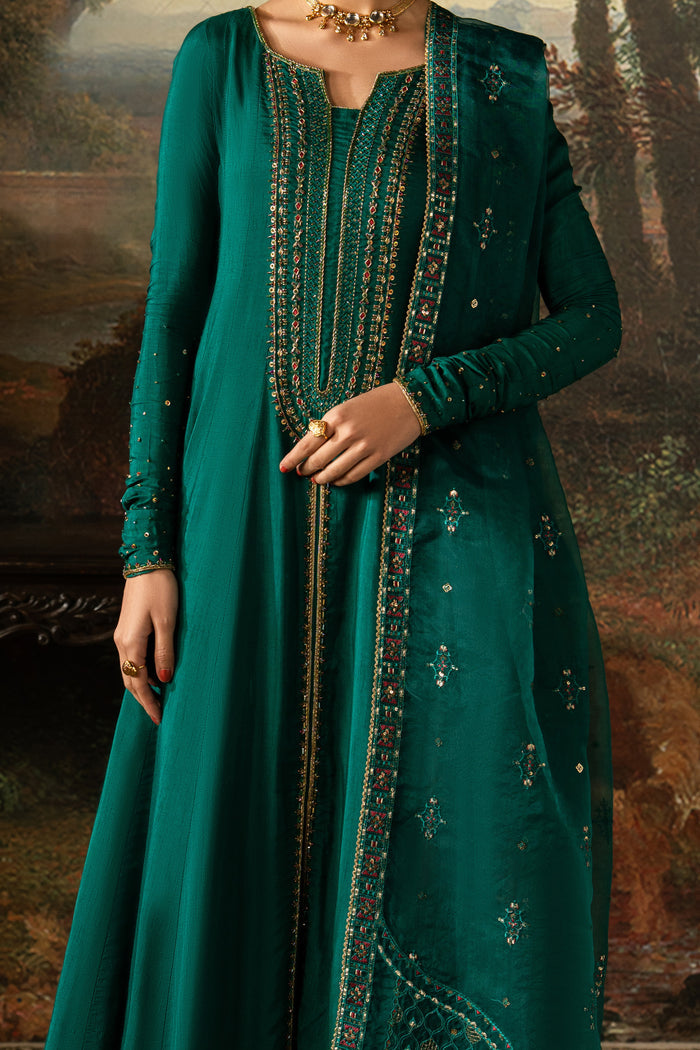 Close-up of Haniya highlighting the boat neckline, front appliqué, machine embroidery, sequins and adda work on the Indian Raw Silk frock.