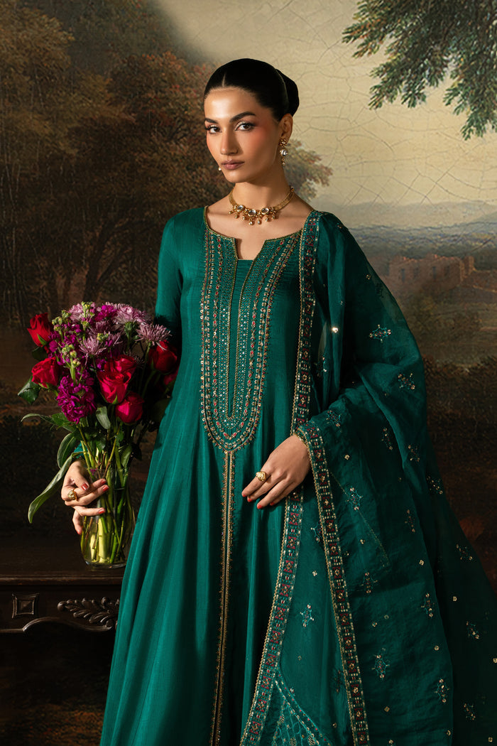 Mid-length front view of Haniya showing the bottle green frock, embroidered neckline and detailed long sleeves.