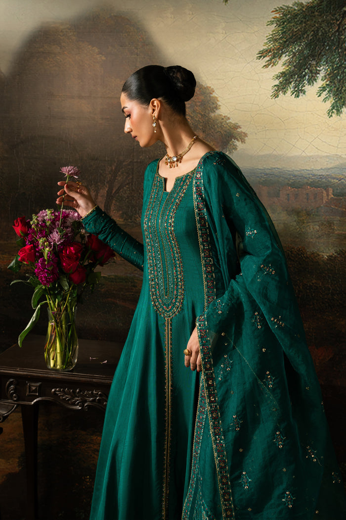 Side pose of Haniya highlighting the flowing eight-panel frock, embroidered sleeve details and draped Organza dupatta.