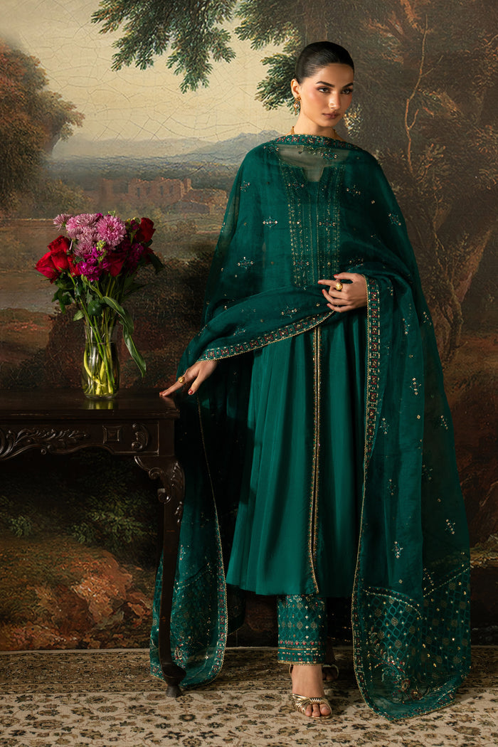 Full-length view of Haniya with the embroidered Organza dupatta wrapped over the bottle green frock and PK Raw Silk culottes.