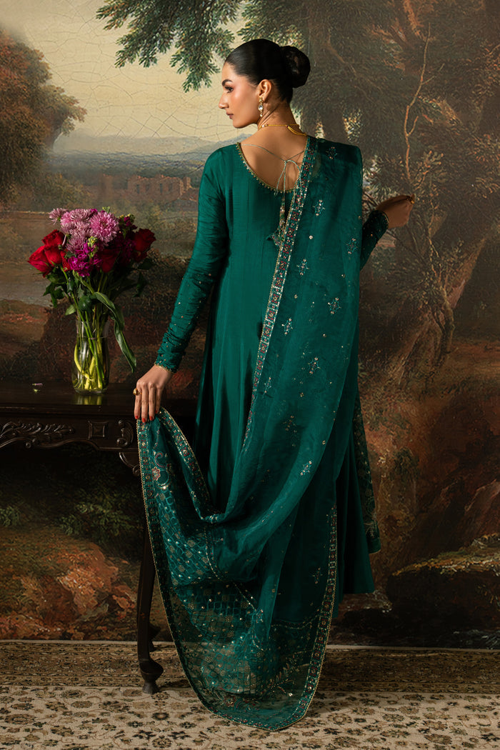 back view view of Haniya showing the wide frock flare, centre opening and softly draped bottle green Organza dupatta.