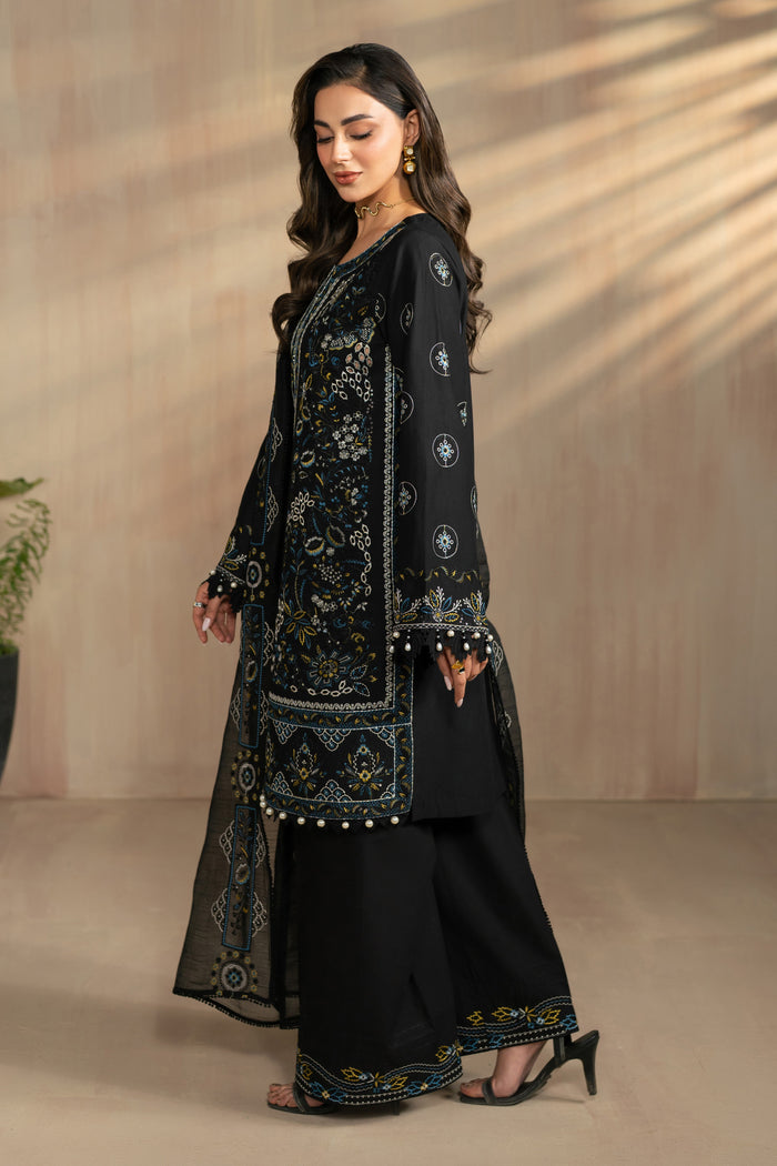 Side standing pose of Hazeem outfit showing straight shirt silhouette and embroidered borders, lightweight ready made eastern summer attire.