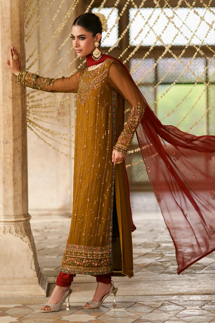 Side view of Huzaim brown crinkle semi formal outfit featuring red contrast dupatta, embellished detailing and elegant festive styling