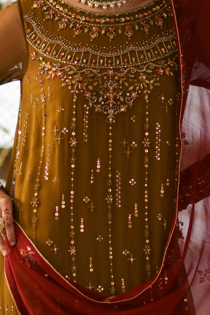 Close-up of Huzaim embellished neckline with sequins work, adda detailing and decorative craftsmanship on brown crinkle shirt